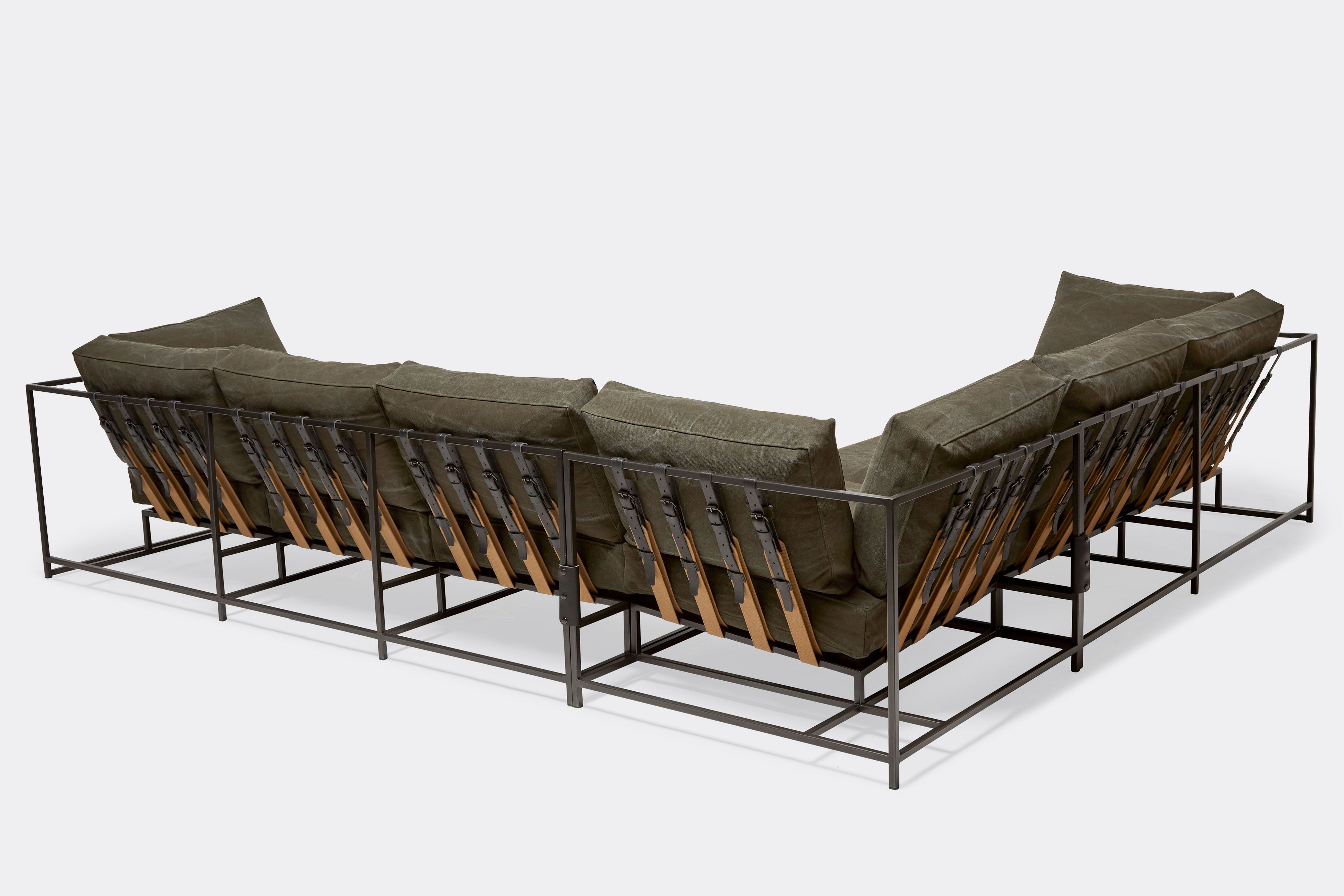 back of sectional with olive canvas upholstery on blackened steel metal frame