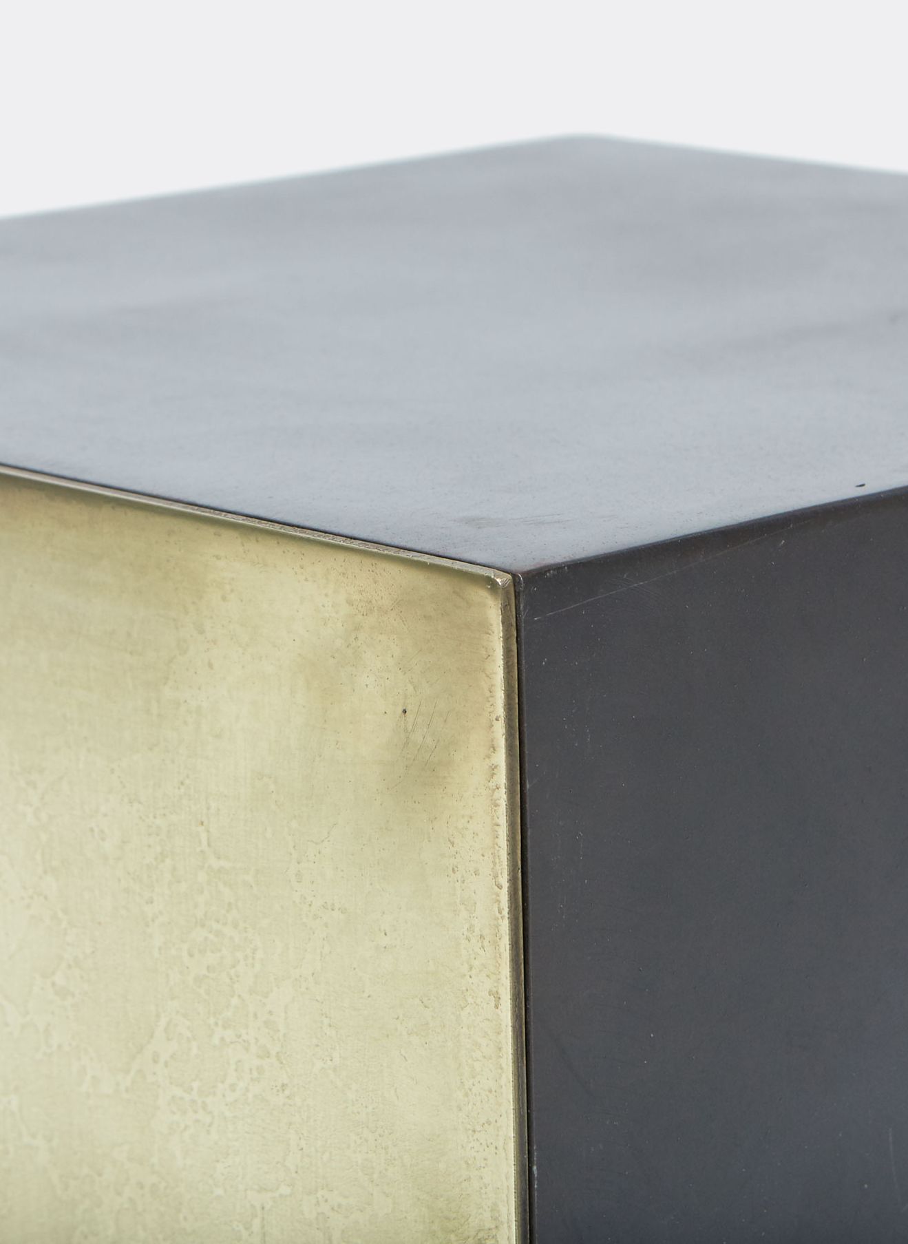 a steel and brass small table shown on a white surface .