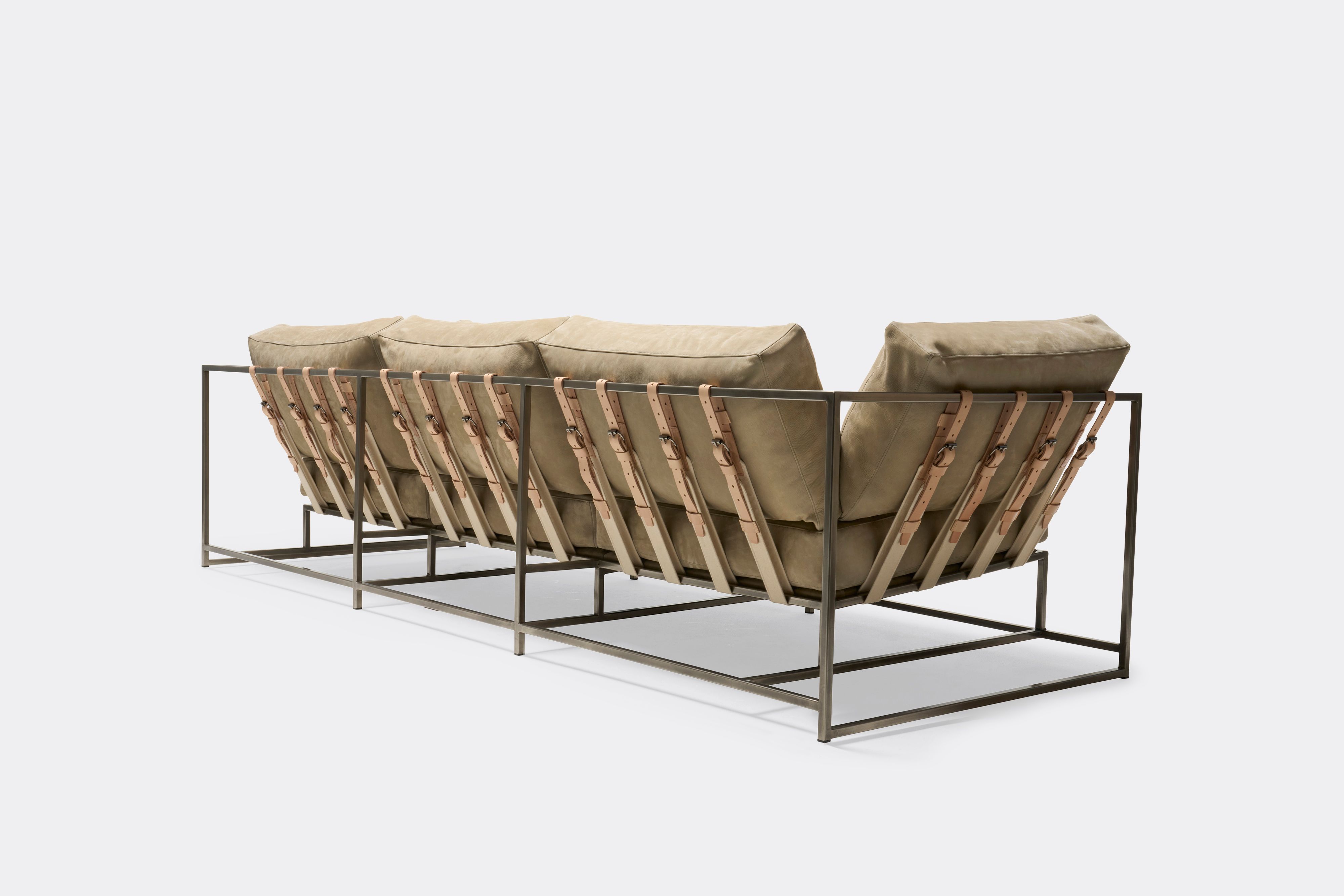 back of Sofa with tan leather upholstery and veg tan leather belts on antique nickel metal frame