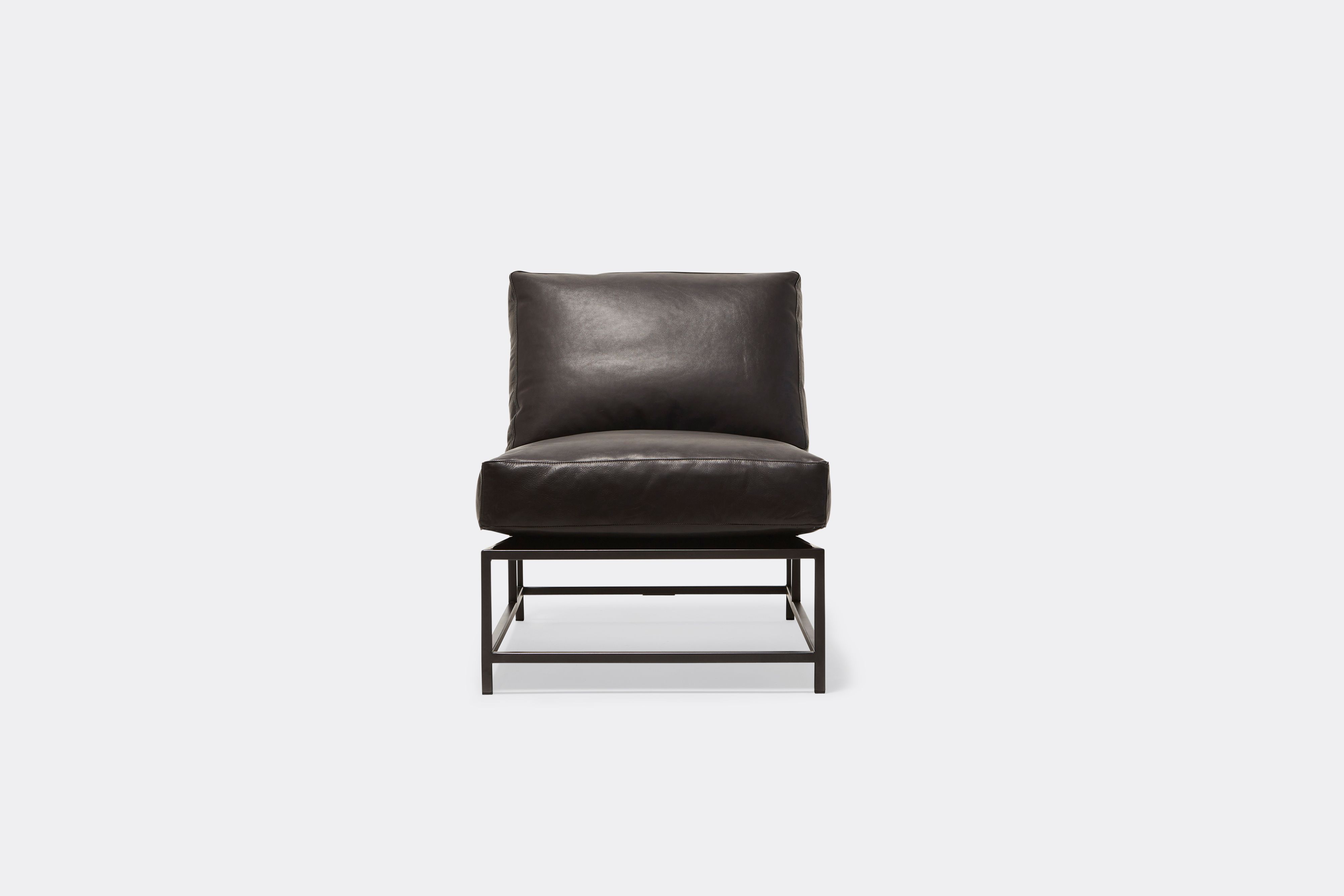 Front of lounge chair withblack leather upholstery and black metal frame