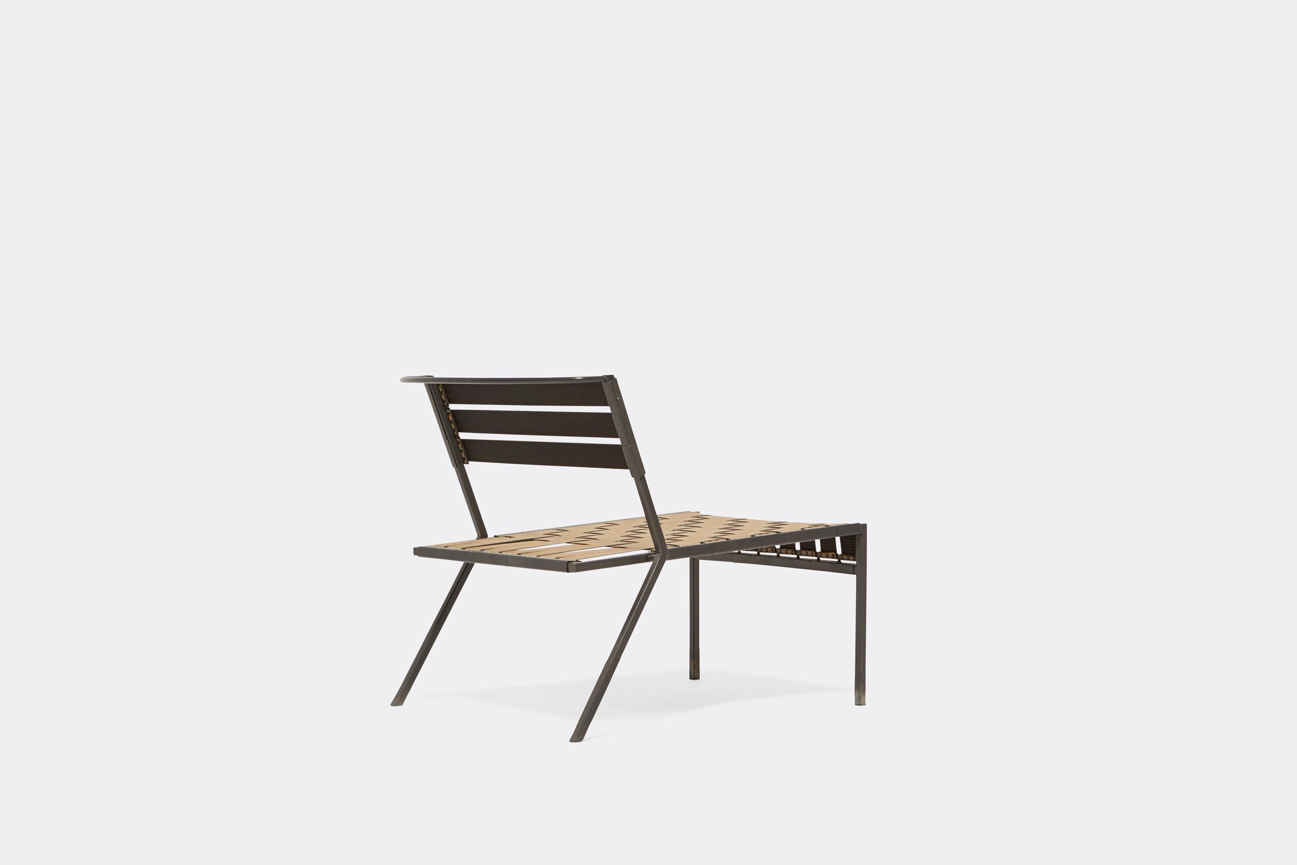 An outdoor steel chair with black metal finish and interwoven tan webbing on a light background