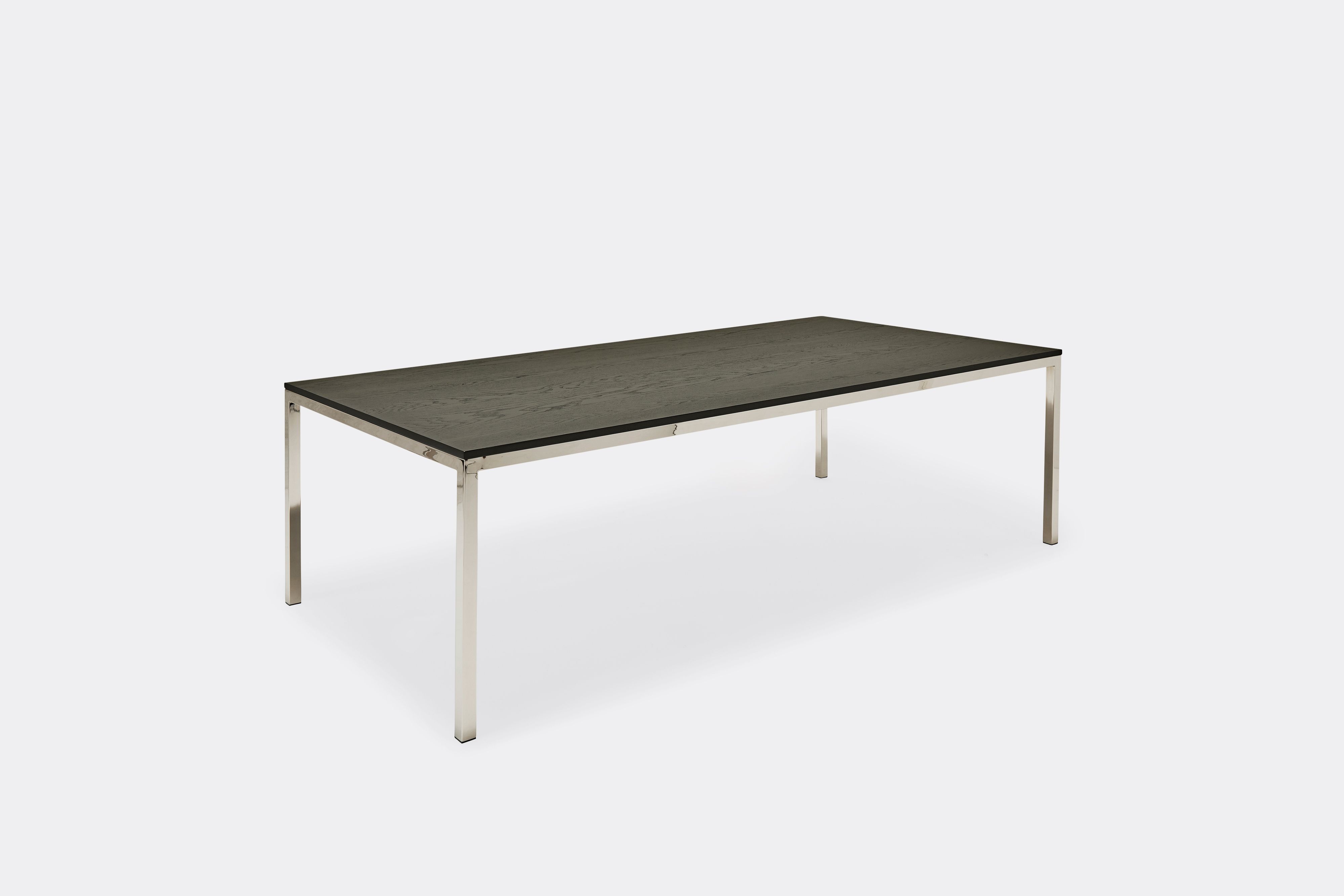 Overhead view of dining table with ebonized oak wood top and polished nickel metal legs