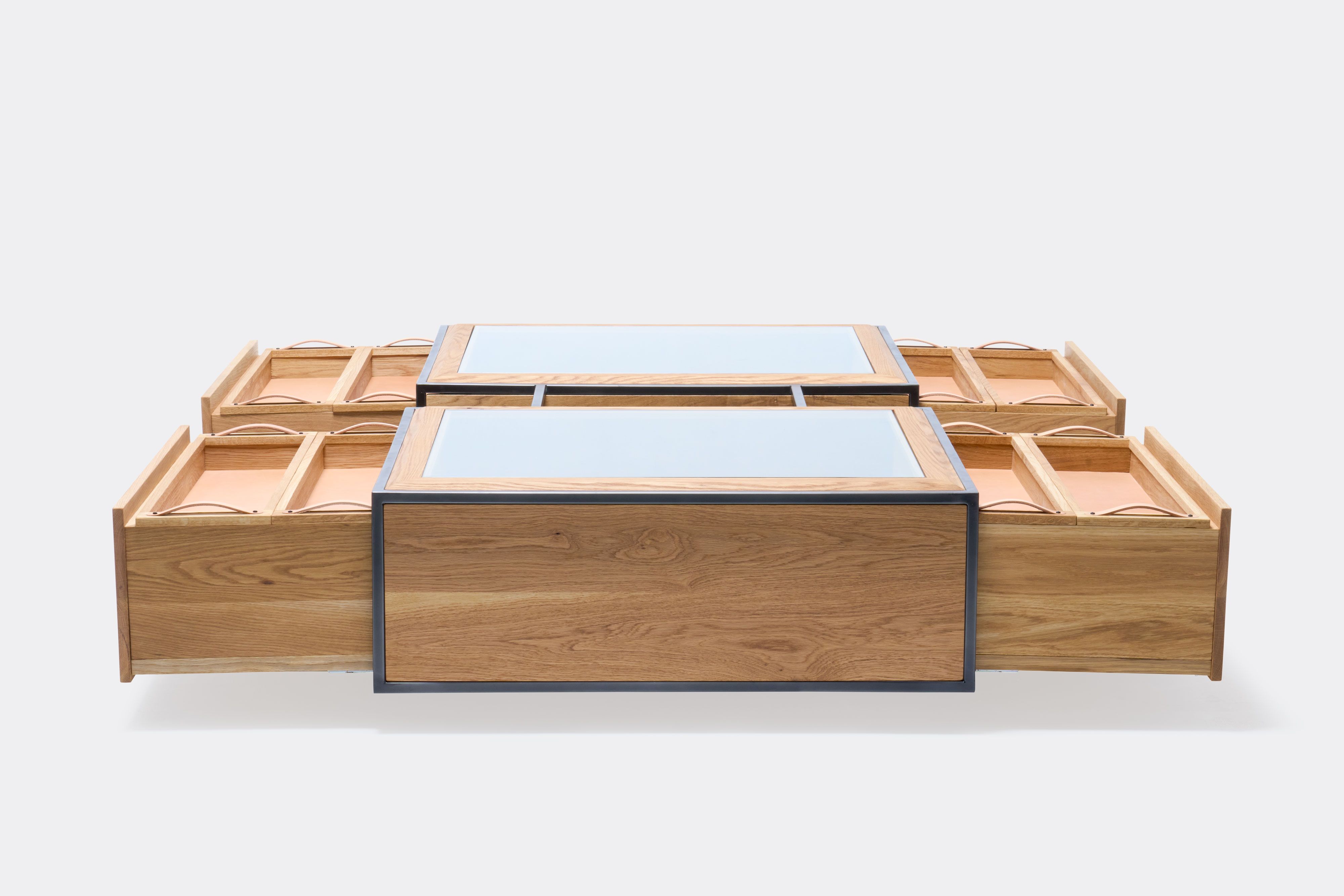 drawers open on double display coffee table with white oak wood, blackened steel metal and glass top