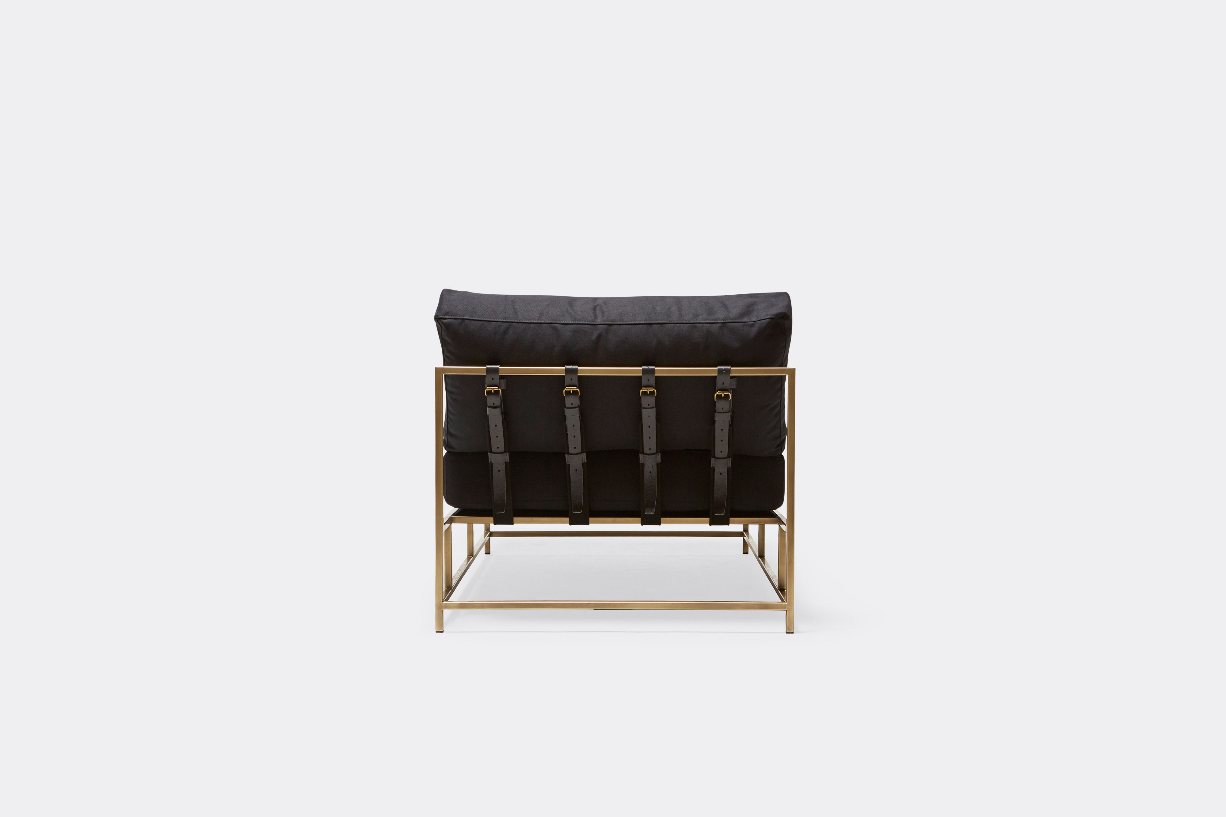 back of Chaise Lounge with black canvas upholstery and black leather belts on antique brass metal frame