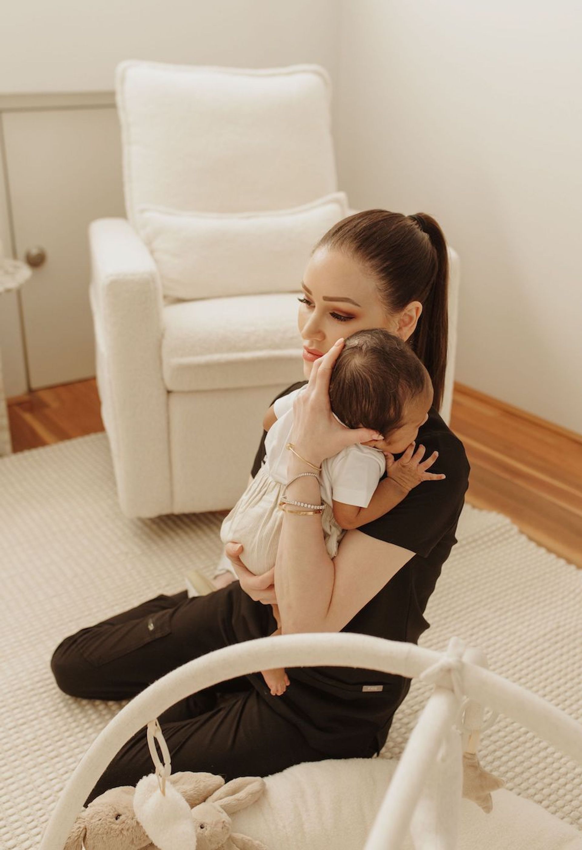 Megan Everett, Nurse Practitioner at Hush Healthcare, providing gentle postnatal and early parenting care while holding an infant in Perth.