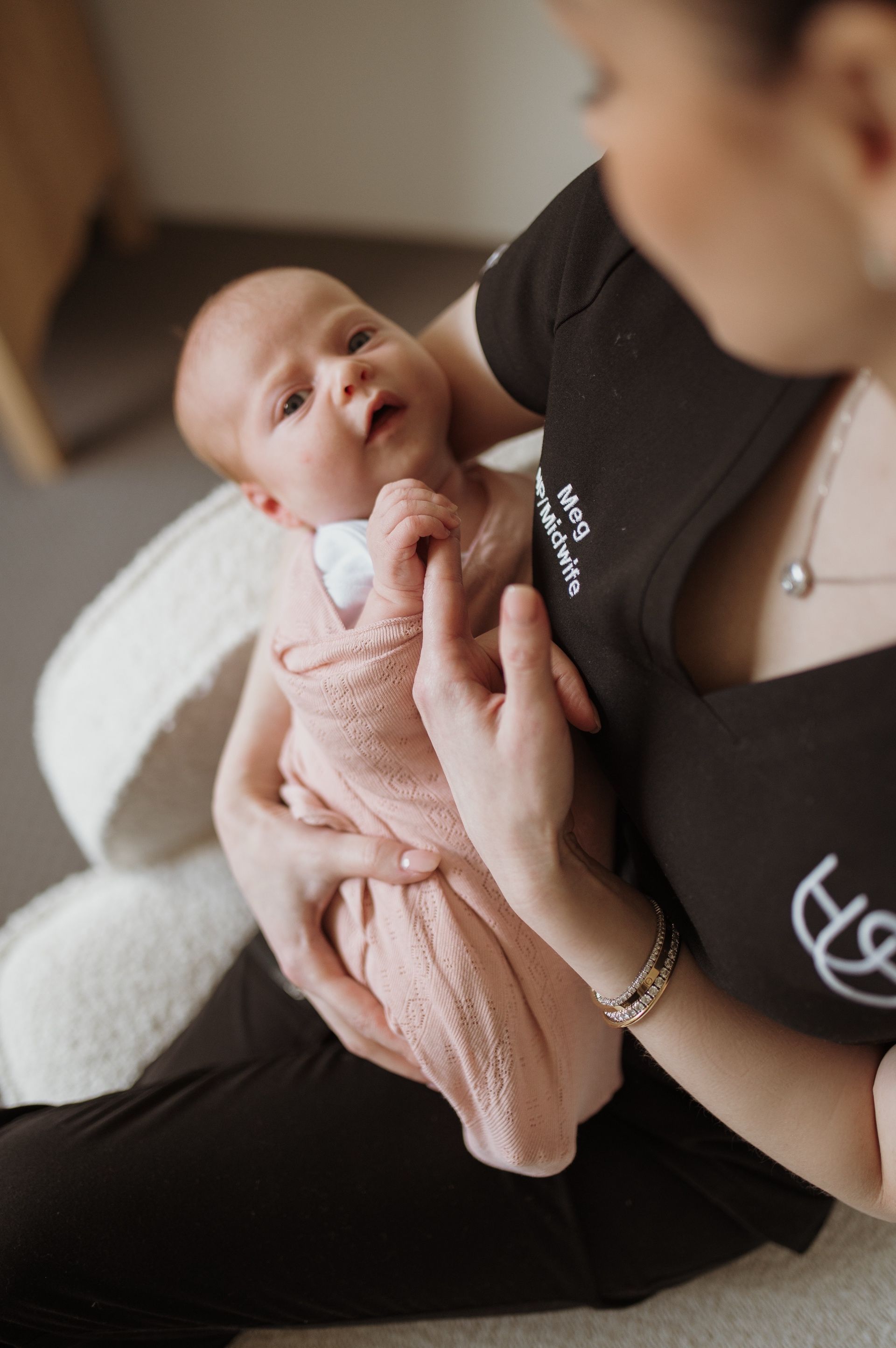 Megan Everett, Founder and Nurse Practitioner at Hush Healthcare, providing gentle postnatal and early parenting care while holding a baby in Perth.