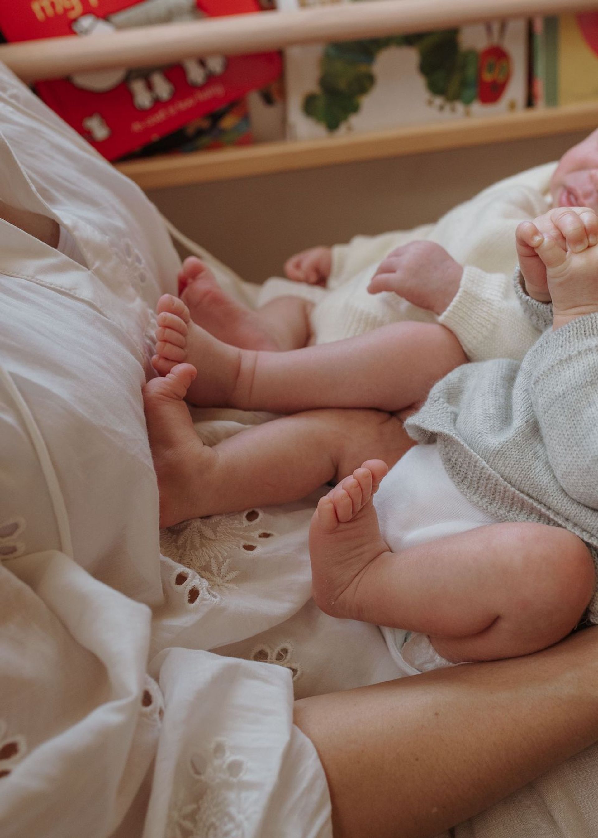 Two newborn babies sleeping next to each other