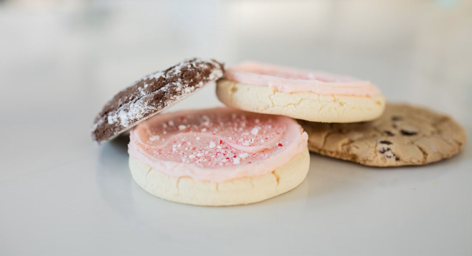 Iced biscuits and cookies stacked on a plate