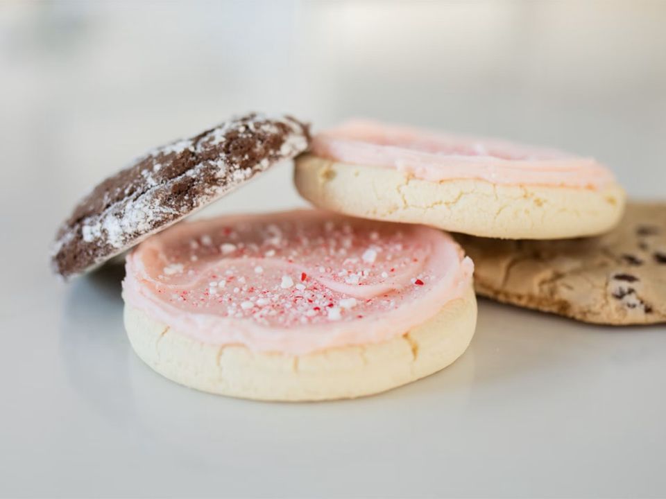 Iced biscuits and cookies stacked on a plate