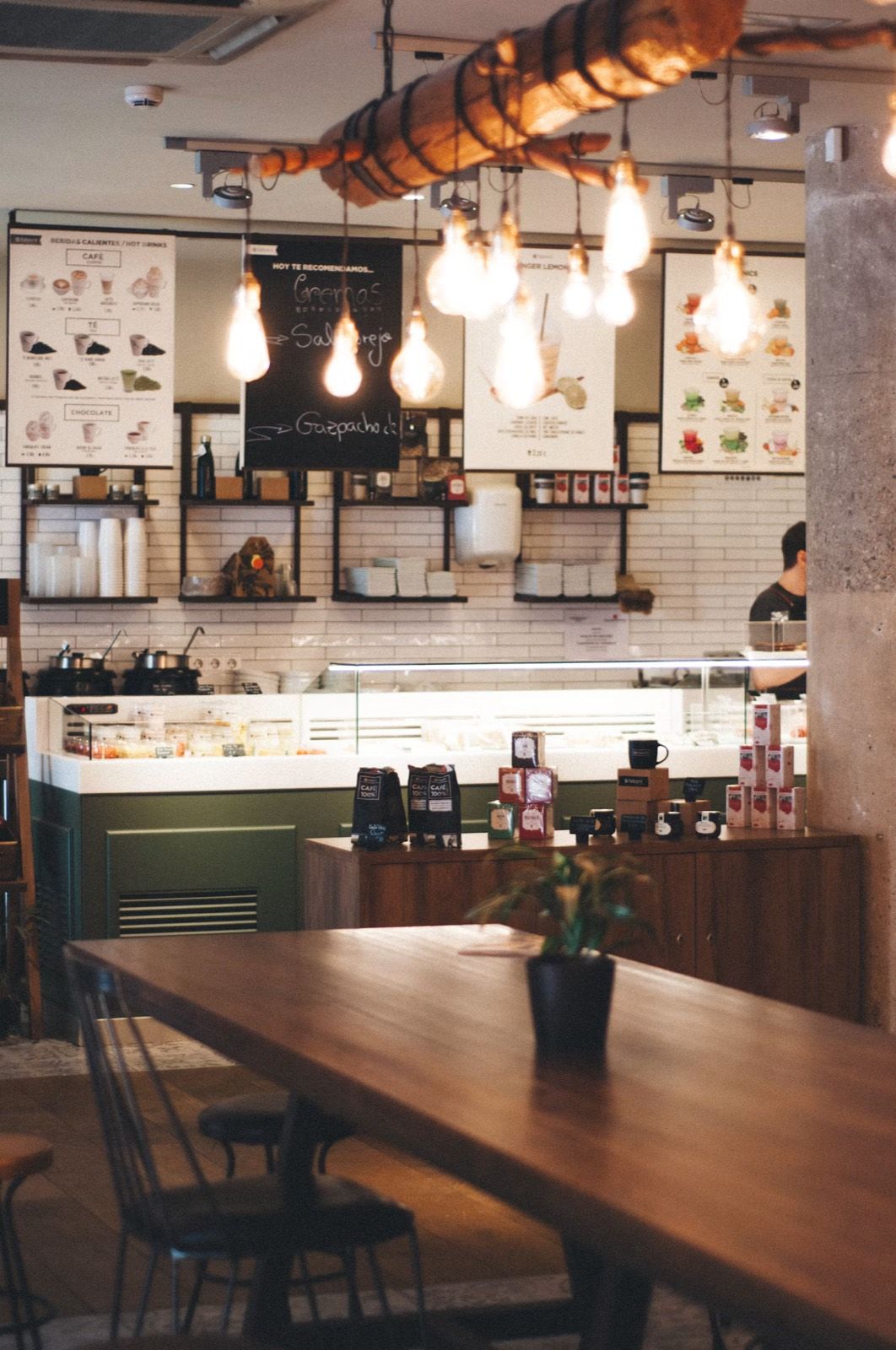 The café counter with jars, pastries and menu boards