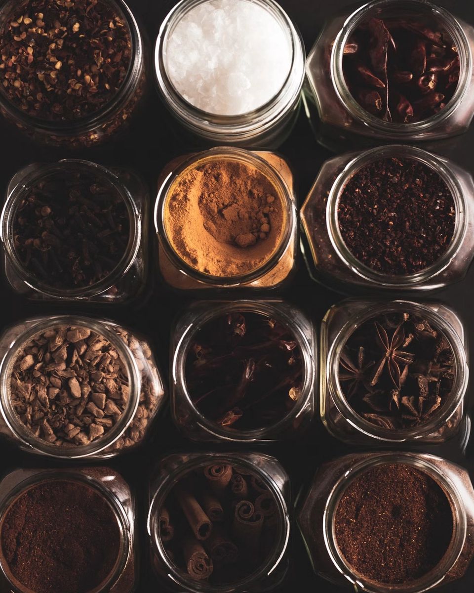Jars of coffee beans, spices and sugar seen from above