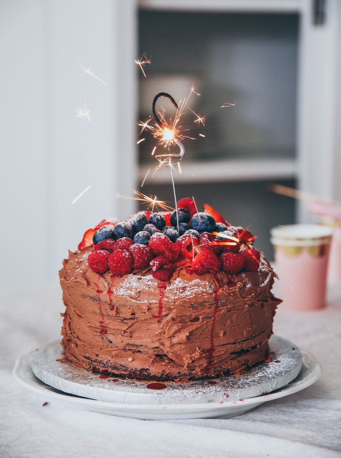 A chocolate celebration cake topped with fresh berries