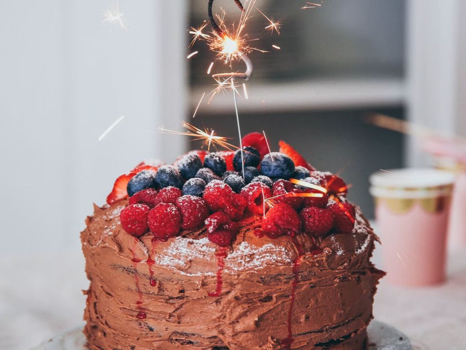 A chocolate celebration cake topped with fresh berries
