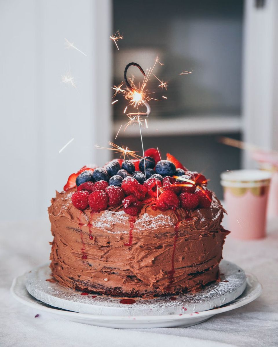 A chocolate celebration cake topped with fresh berries