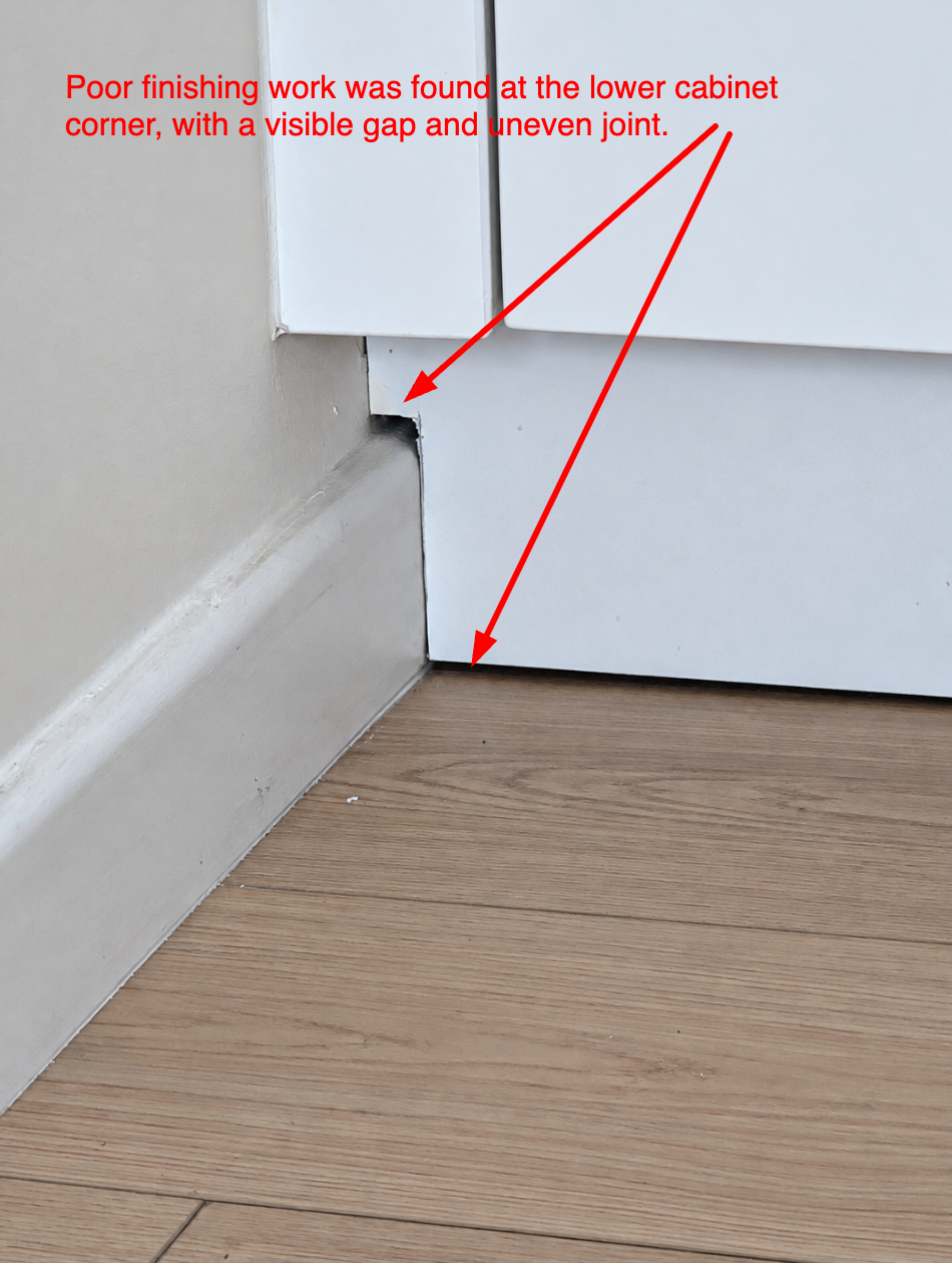 Kitchen cabinet meeting the skirting board, with a visible gap and an uneven joint at the corner.