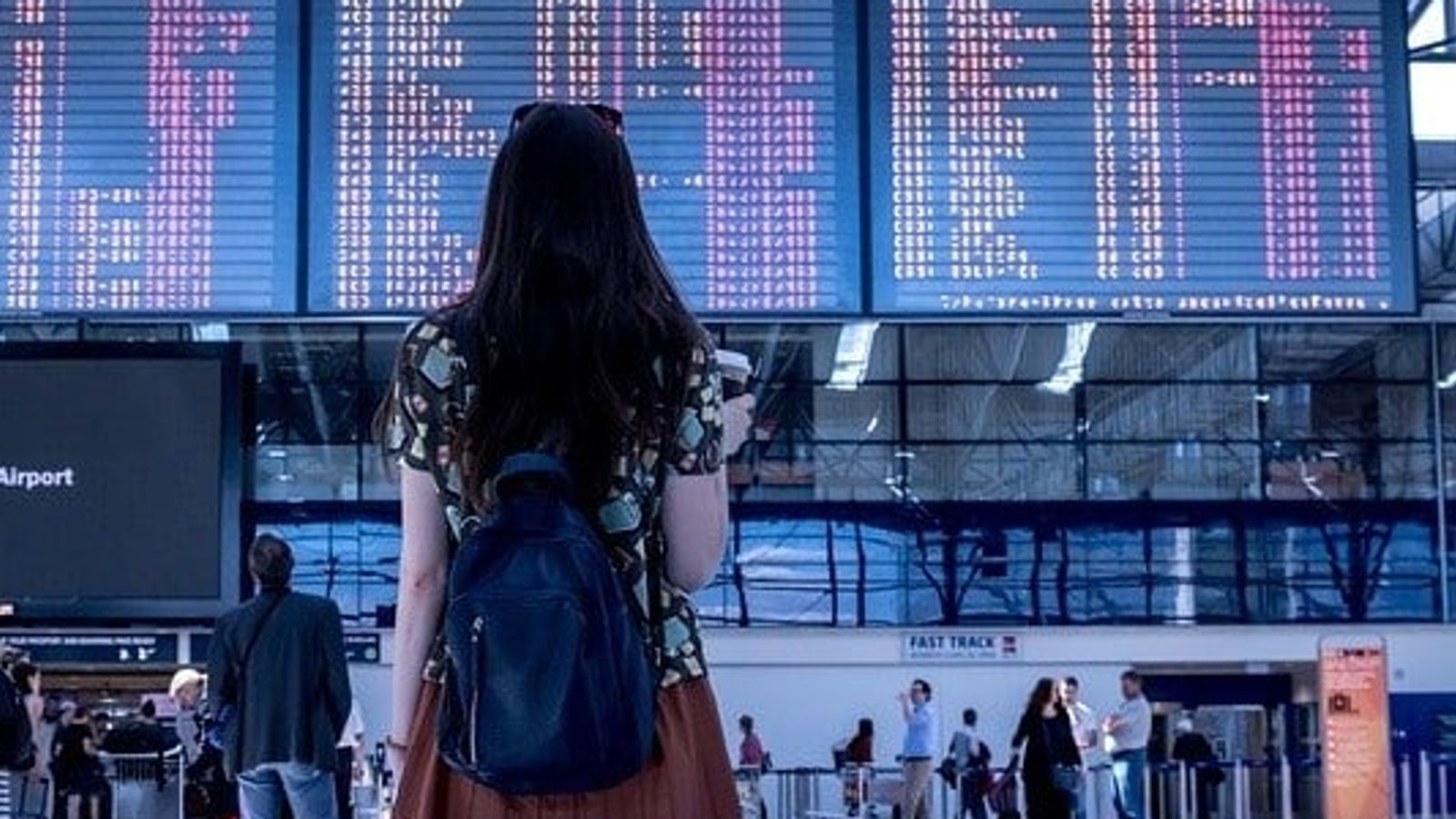 Girl looking at a screen in airport