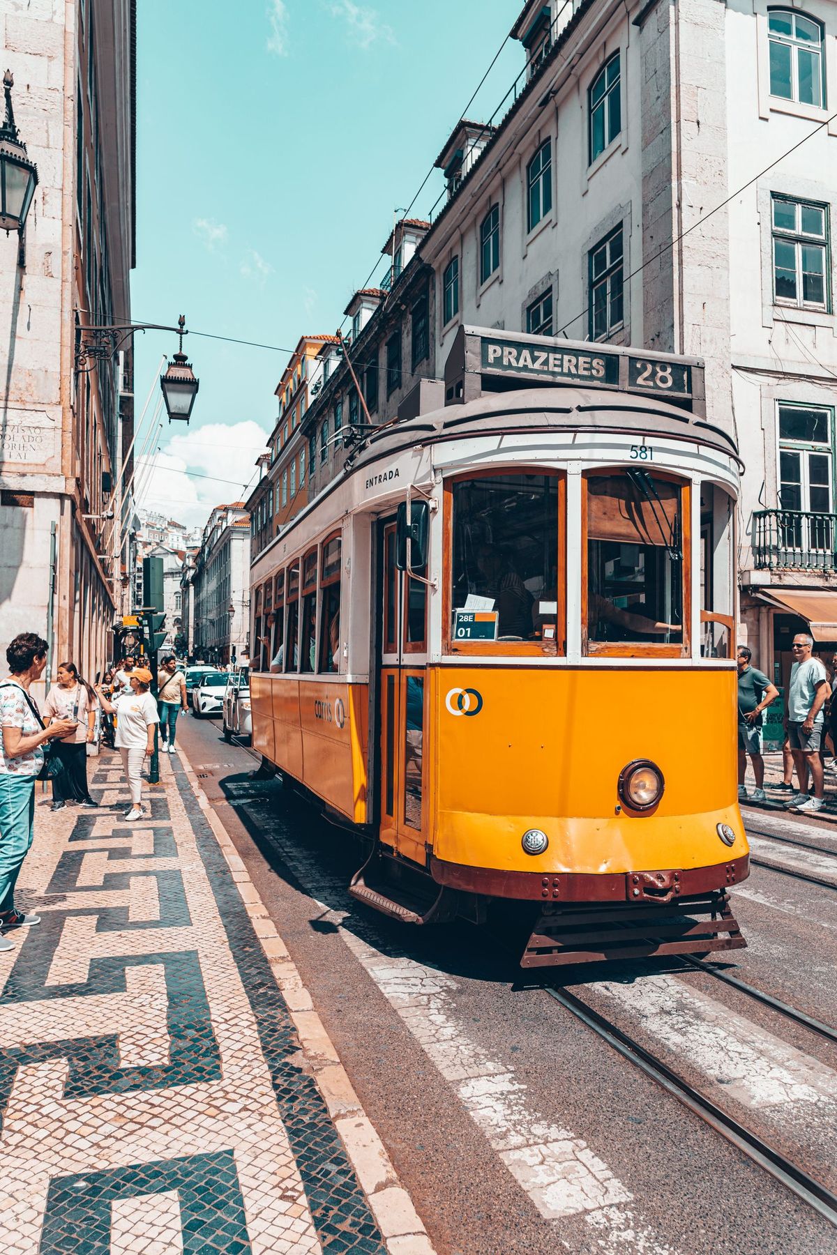 Lisbon's iconic yellow Tram 28 climbing through the historic city center