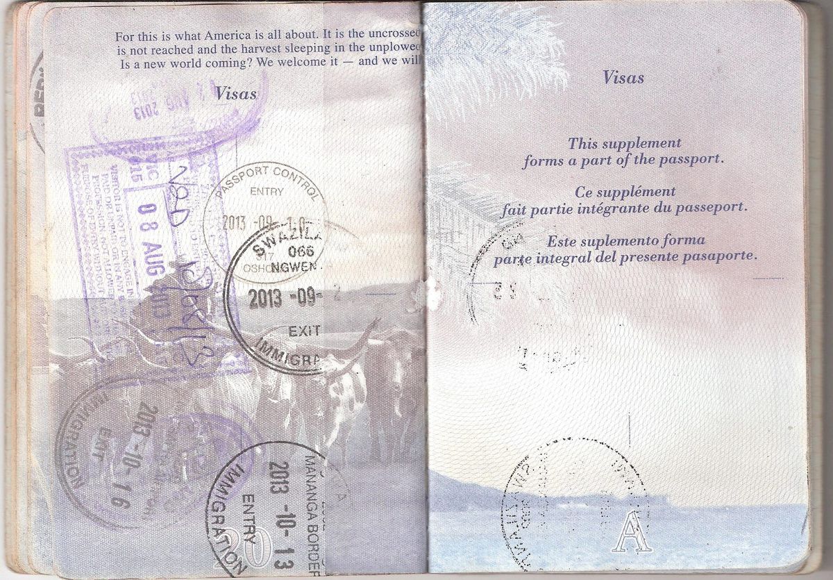 Open US passport pages with entry and exit stamps
