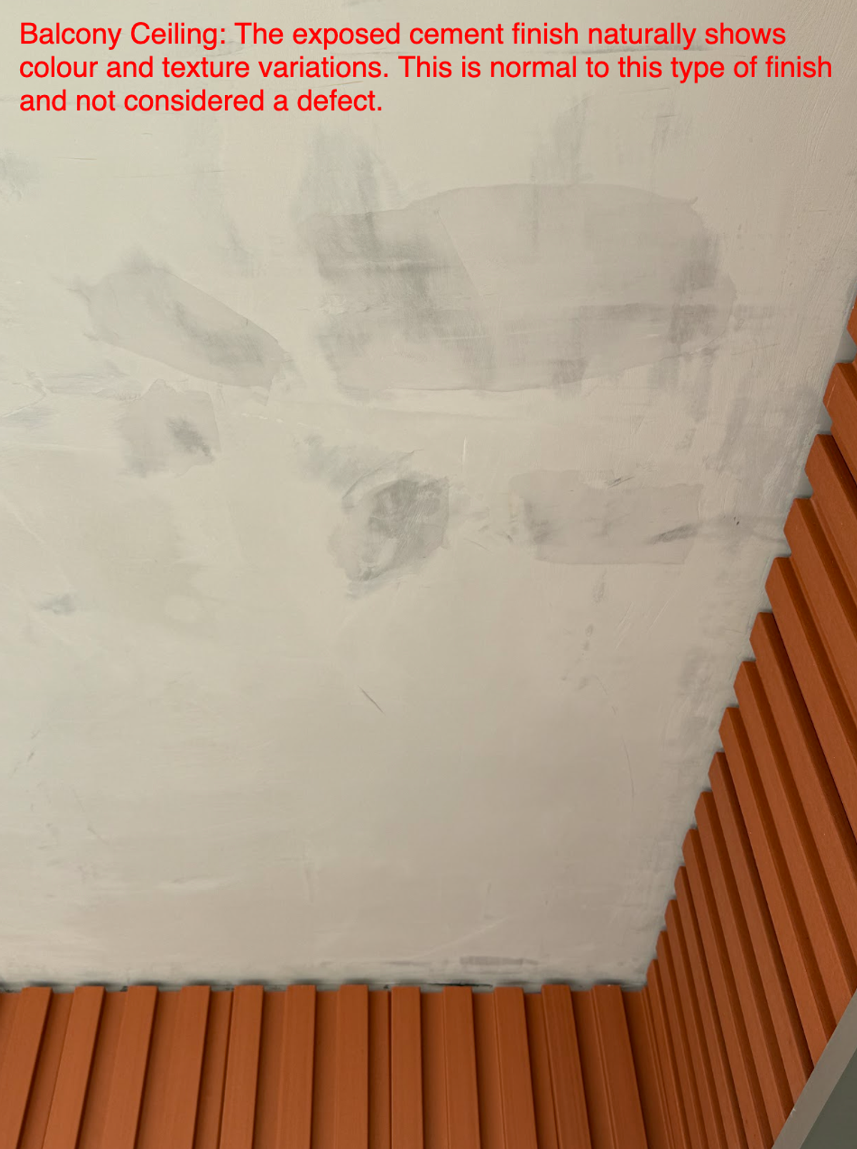 A balcony ceiling in exposed cement, showing the natural colour and texture variation of that finish.