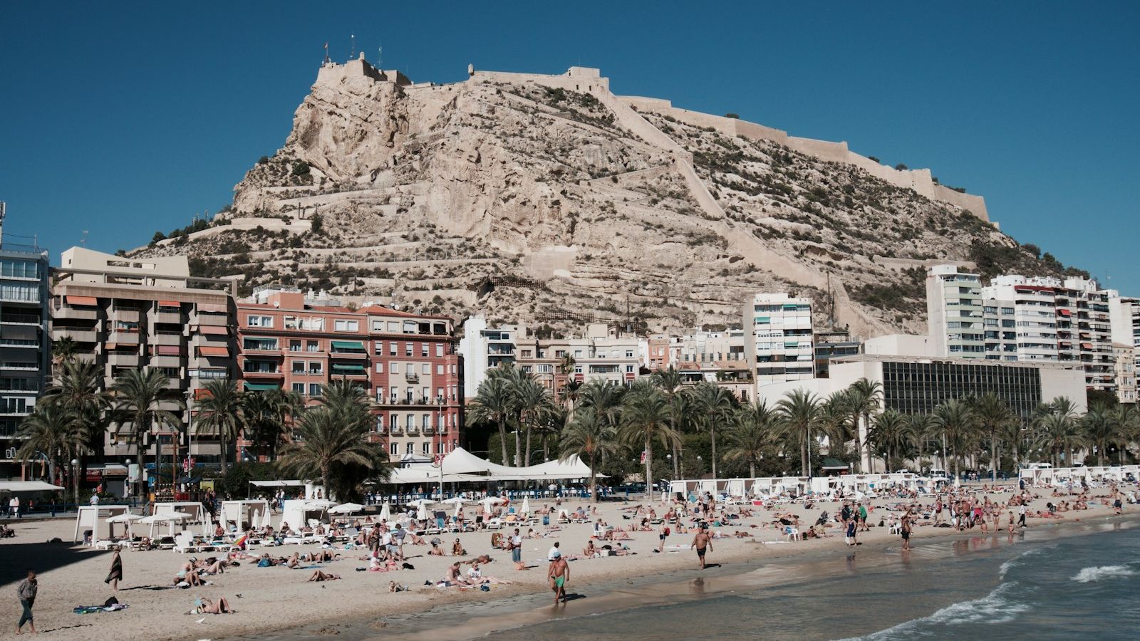 Postiguet Beach below Santa Barbara Castle in Alicante, Spain