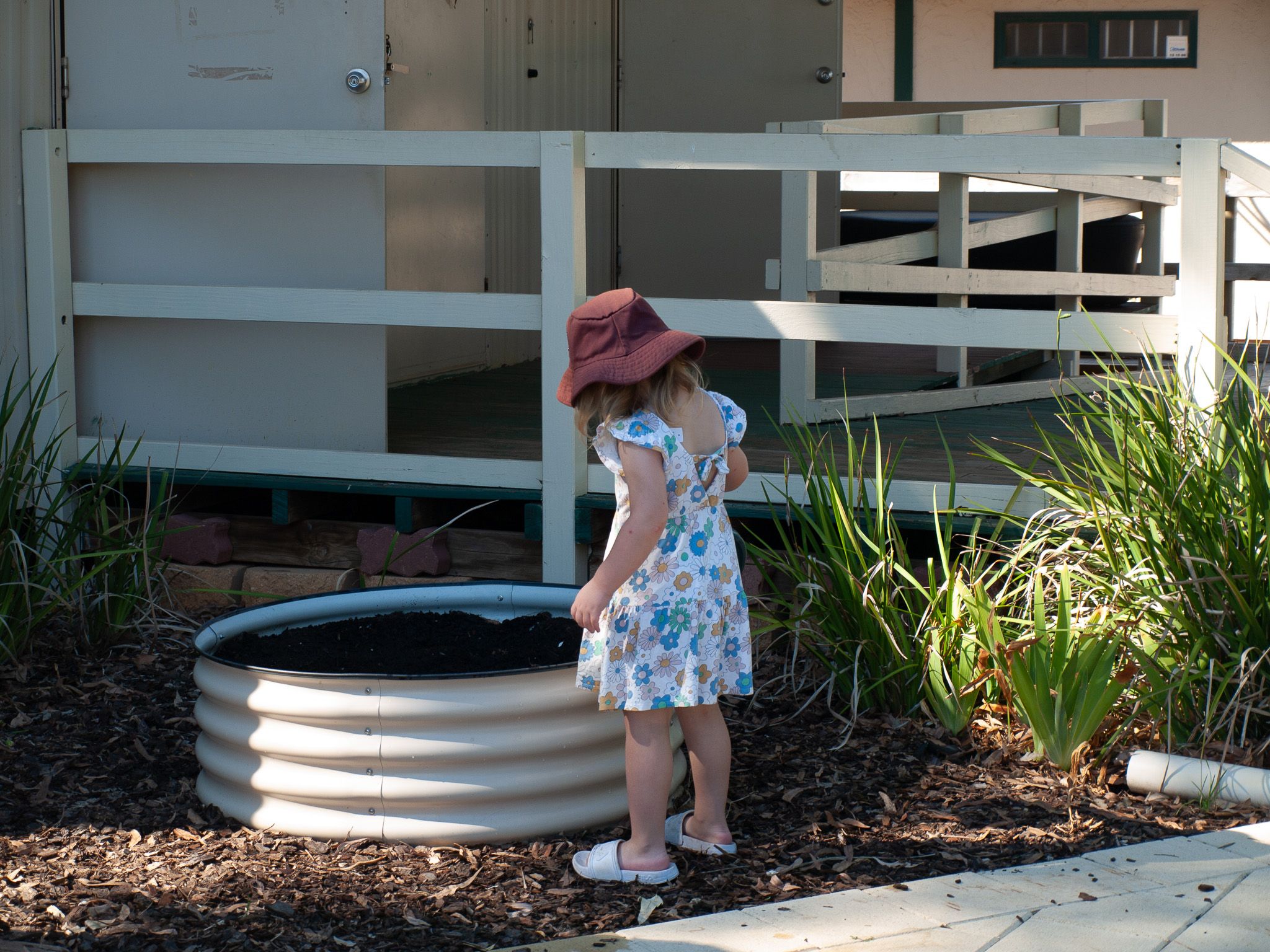 Picture of a child near a small garden bed