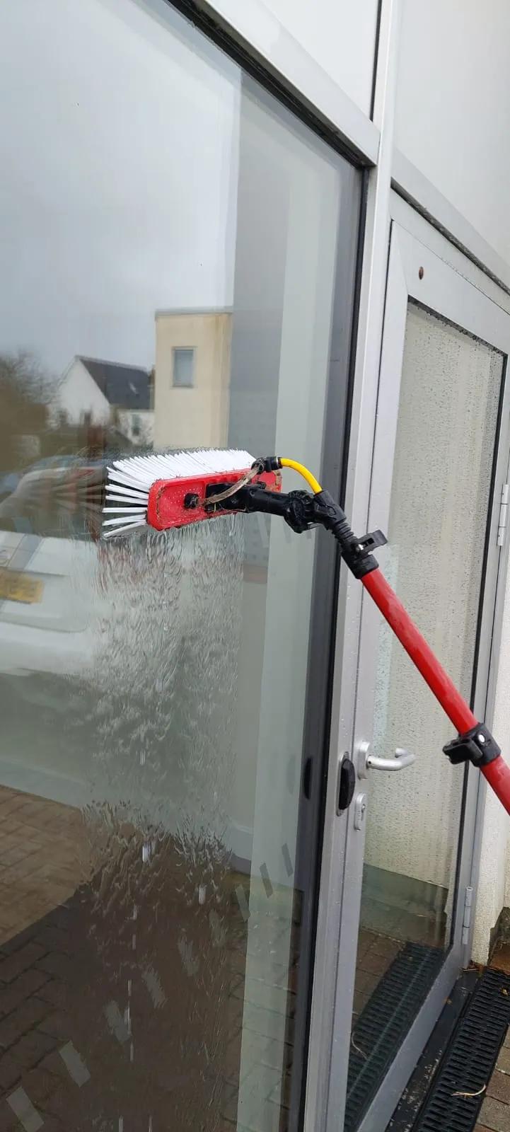Close up of a brush cleaning a window