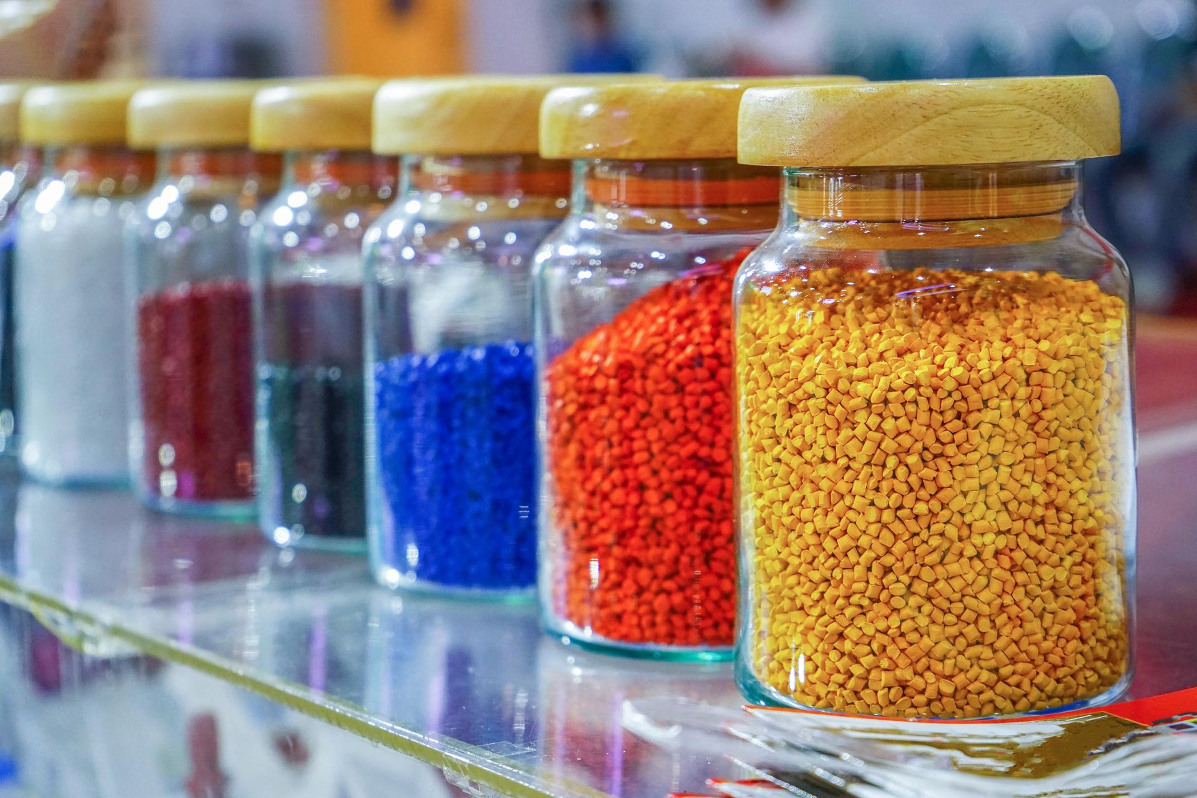 Colored plastic polymer pellets in jars
