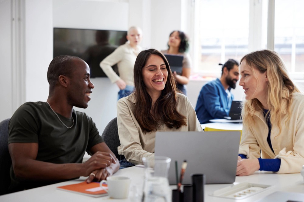 three people in a group talking