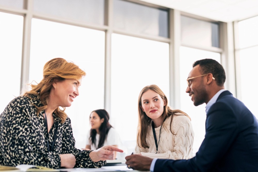 Three people talking in a group