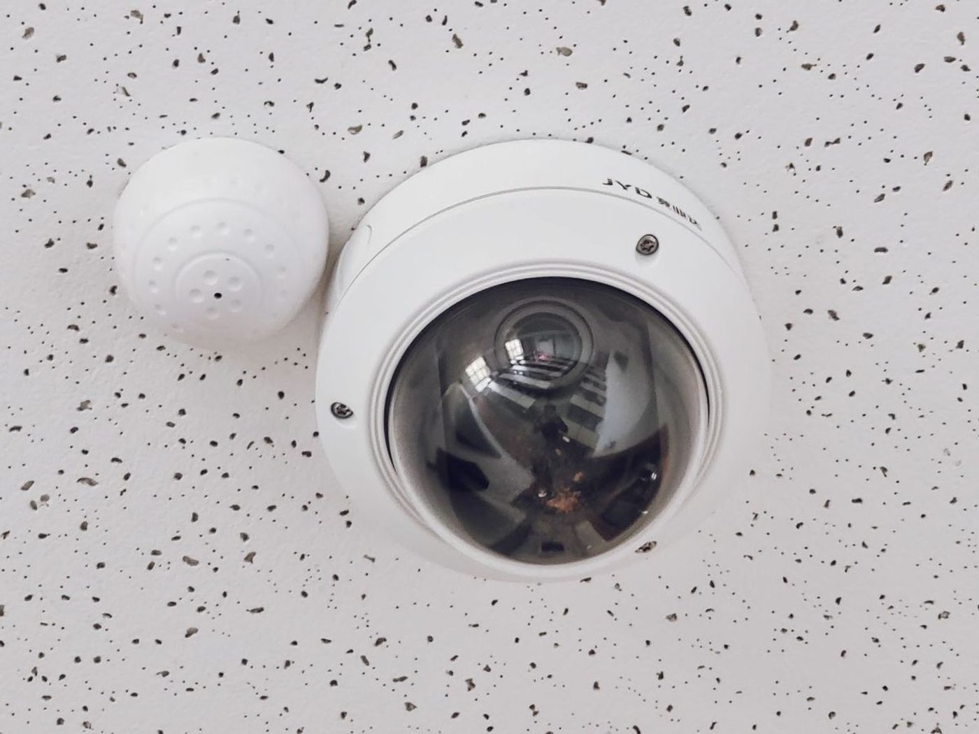 Dome security camera installed on a ceiling