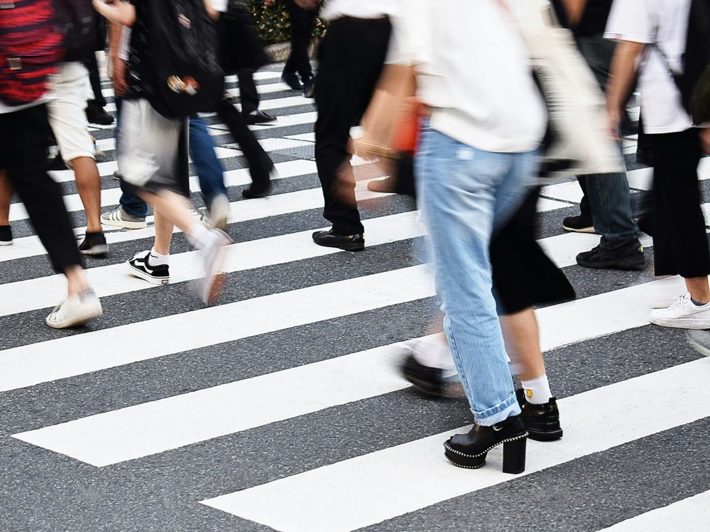 People walking across a pedestrian crossing