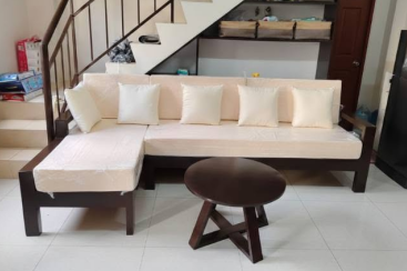 A matching dark wood, round tripod center table sits in the middle of the layout.