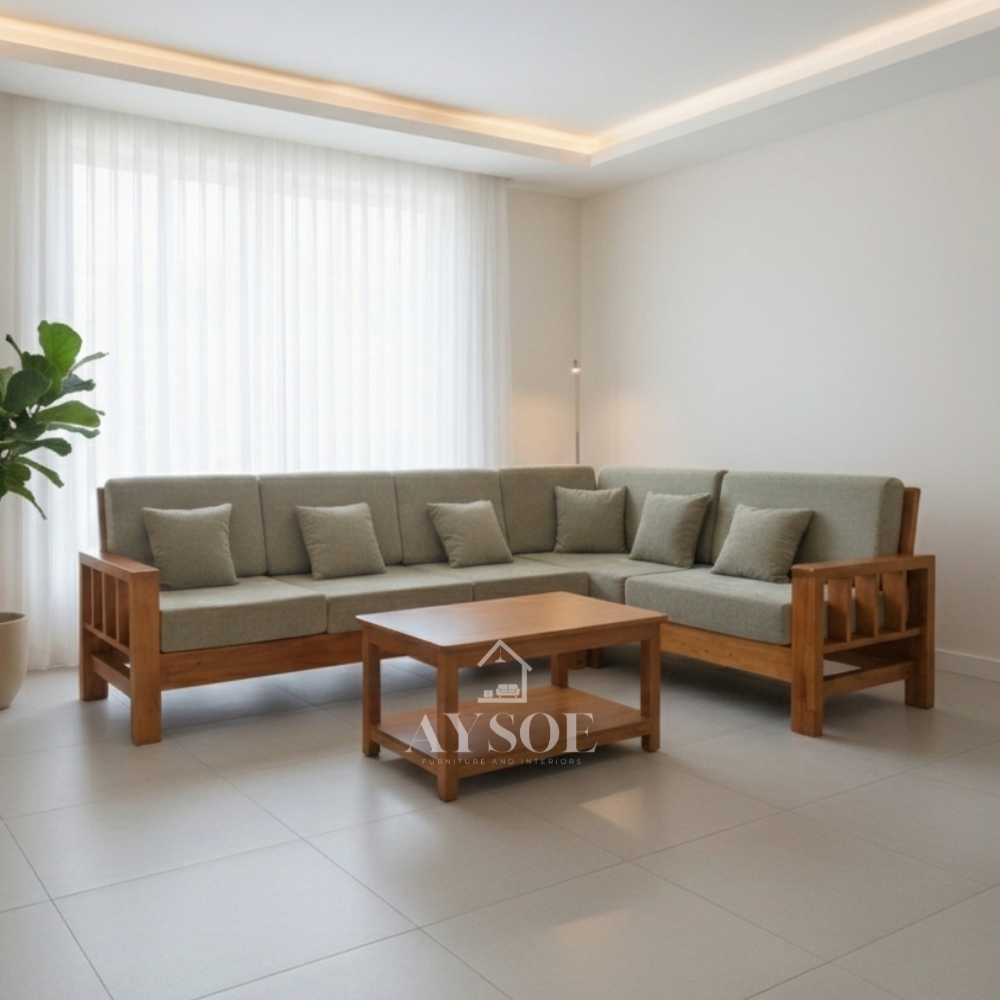 It is topped with thick, structured cushions upholstered in a sage green or muted olive fabric, complete with several small matching square throw pillows.