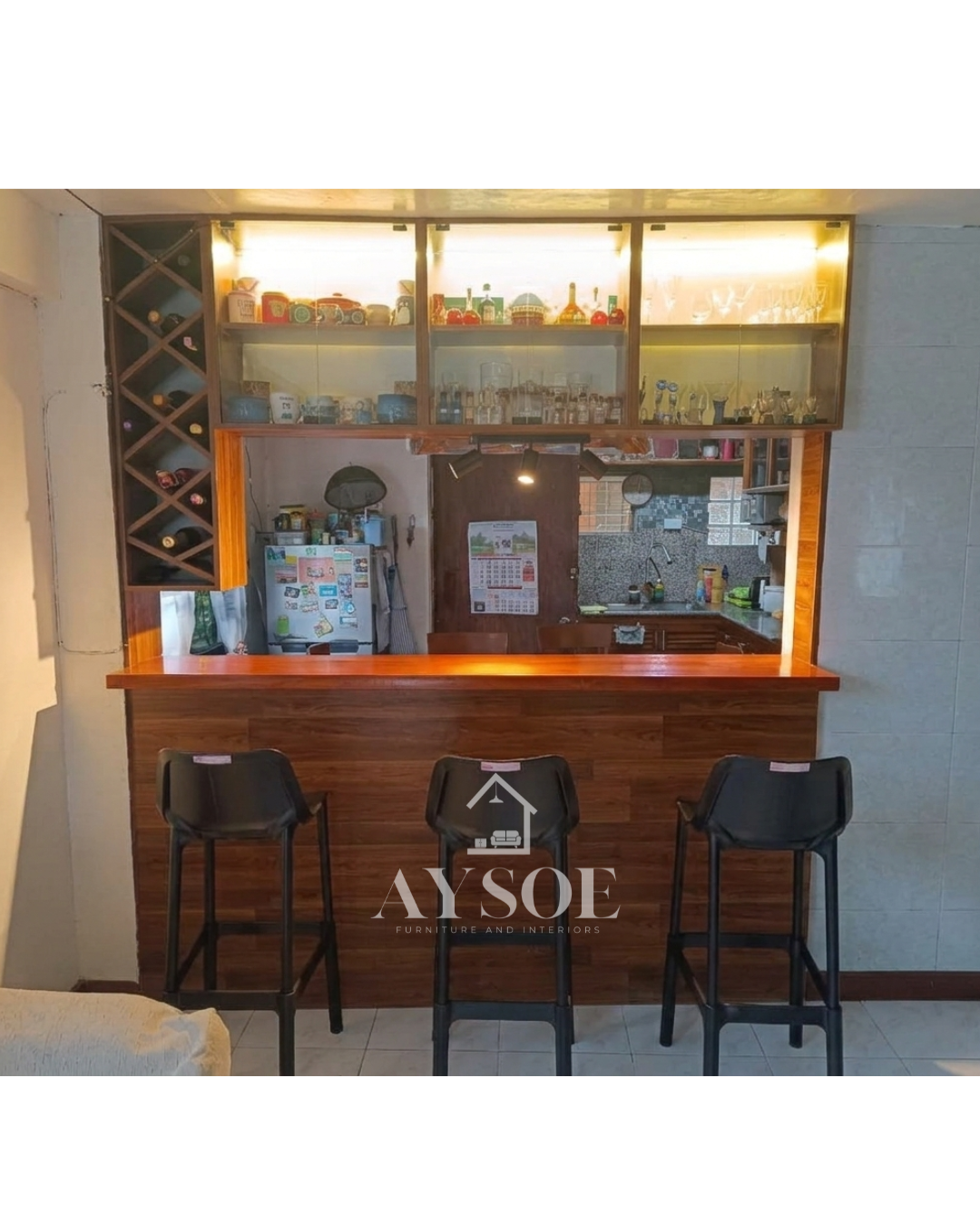 A custom home bar counter with a walnut wood-grain front, a glossy bar top, lighted glass display cabinets, and a diamond wine rack. Turns a kitchen opening into a stylish bar.