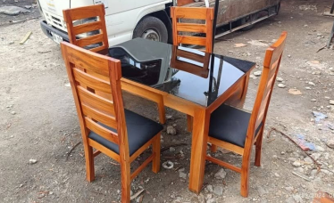 4 chairs with top glass on the table and foam in top also of the chairs.