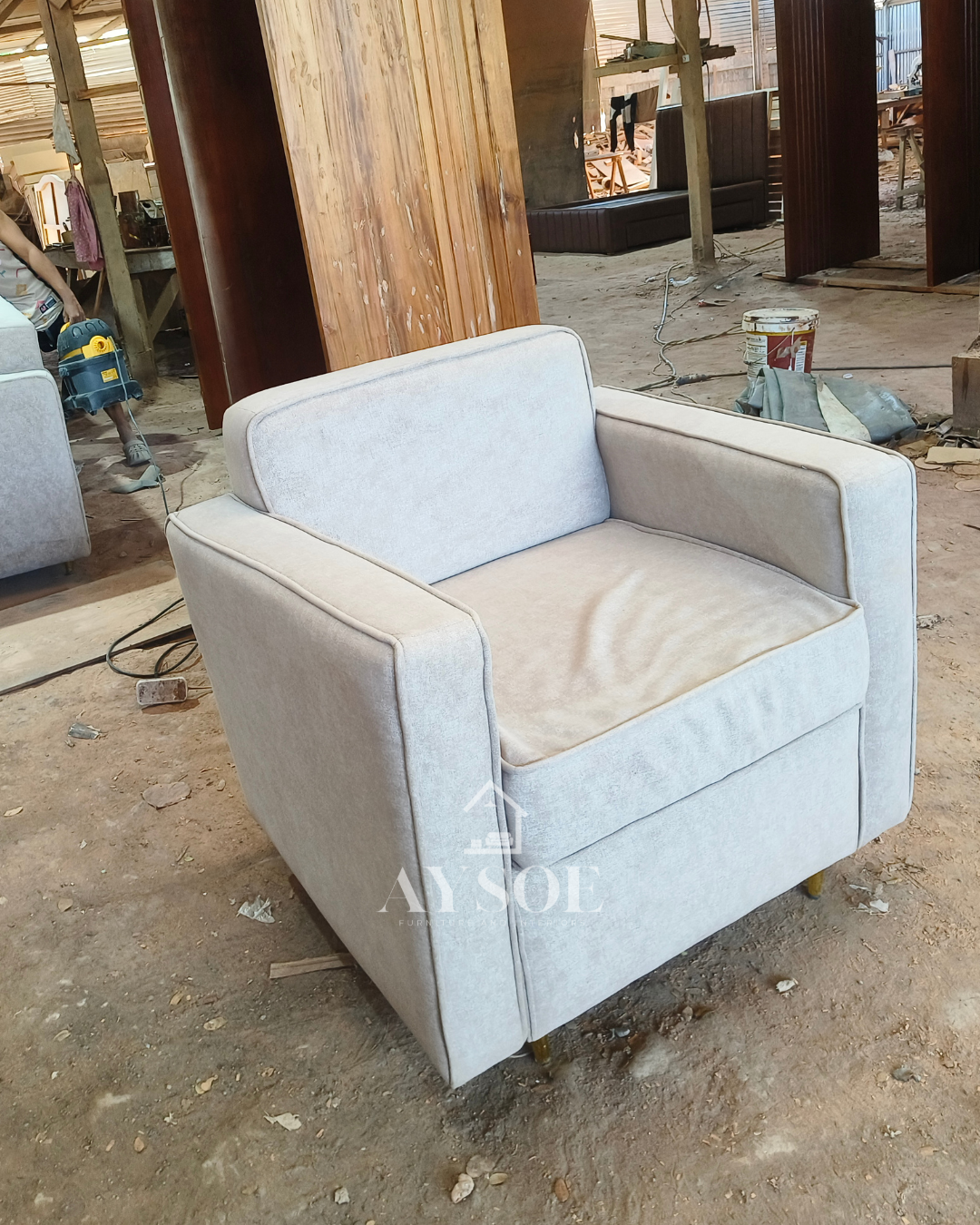 A modern 2-piece living set in soft light grey fabric: a two-seater loveseat and a matching armchair with thick cushions and slim gold legs. Compact, comfortable, and stylish.