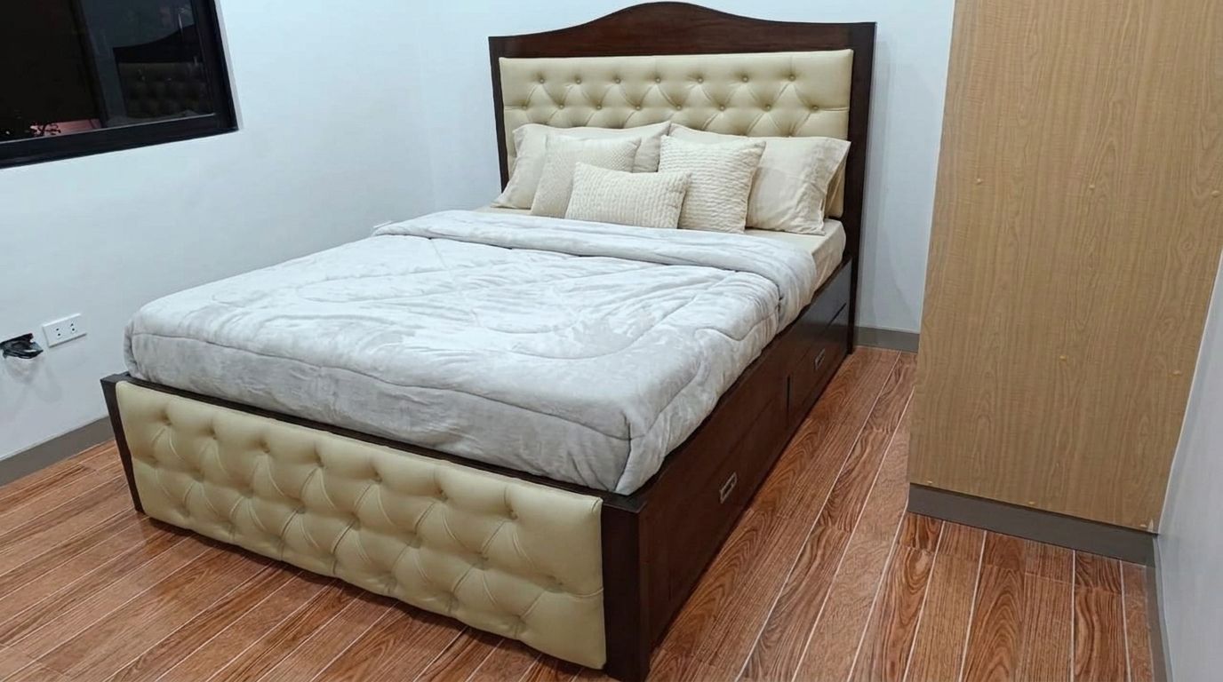 A solid wood bed in a deep walnut finish, with an arched headboard, cream button-tufted leatherette panels on the headboard and footboard, a slatted base, and built-in side drawers. Classic, warm, and practical.