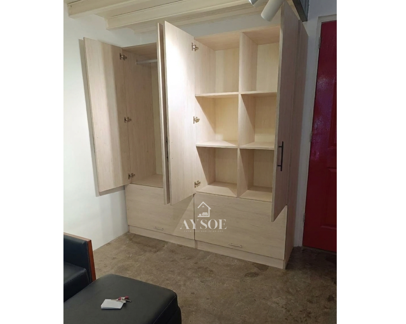 A custom light oak wardrobe with a hanging rod, six cube shelves, and two roomy bottom drawers. Organized storage for clothes, shoes, and linens.