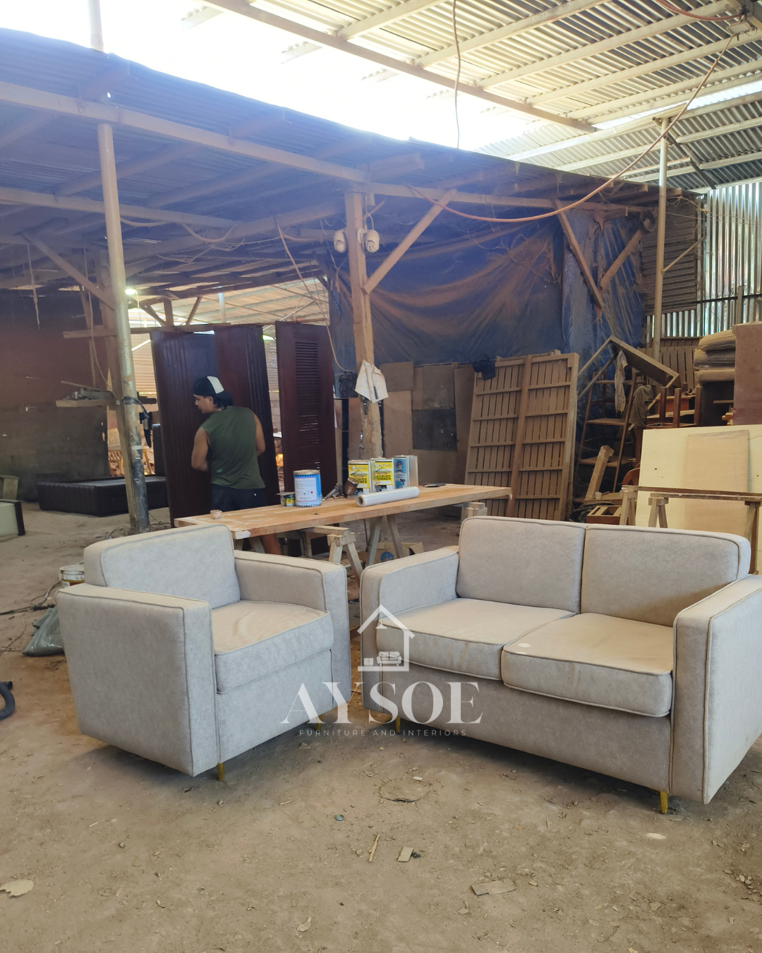 A modern 2-piece living set in soft light grey fabric: a two-seater loveseat and a matching armchair with thick cushions and slim gold legs. Compact, comfortable, and stylish.