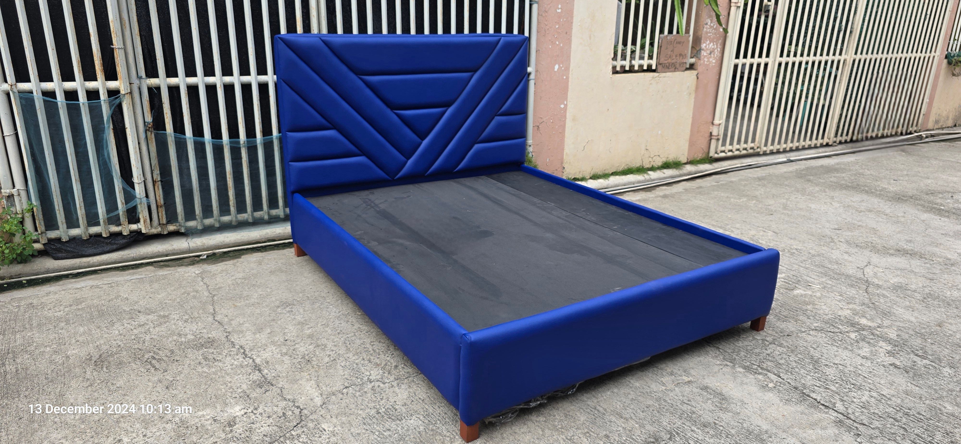 Constructed from a mahogany wood bed frame and upholstered with leatherette.