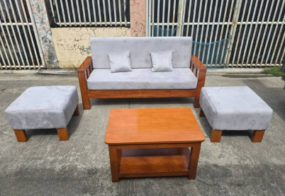 The Coffee Table: A matching wooden center table sits in the middle, featuring a two-tiered design with a lower shelf for storage.