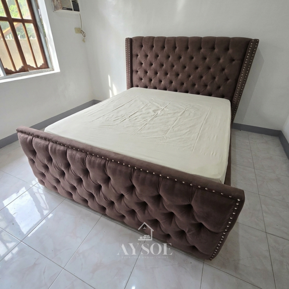 Mocha suede-style bed with a tufted wingback headboard, matching footboard, and nailhead trim. Warm wood side drawers add storage. Available in various sizes, in fabric or leather.