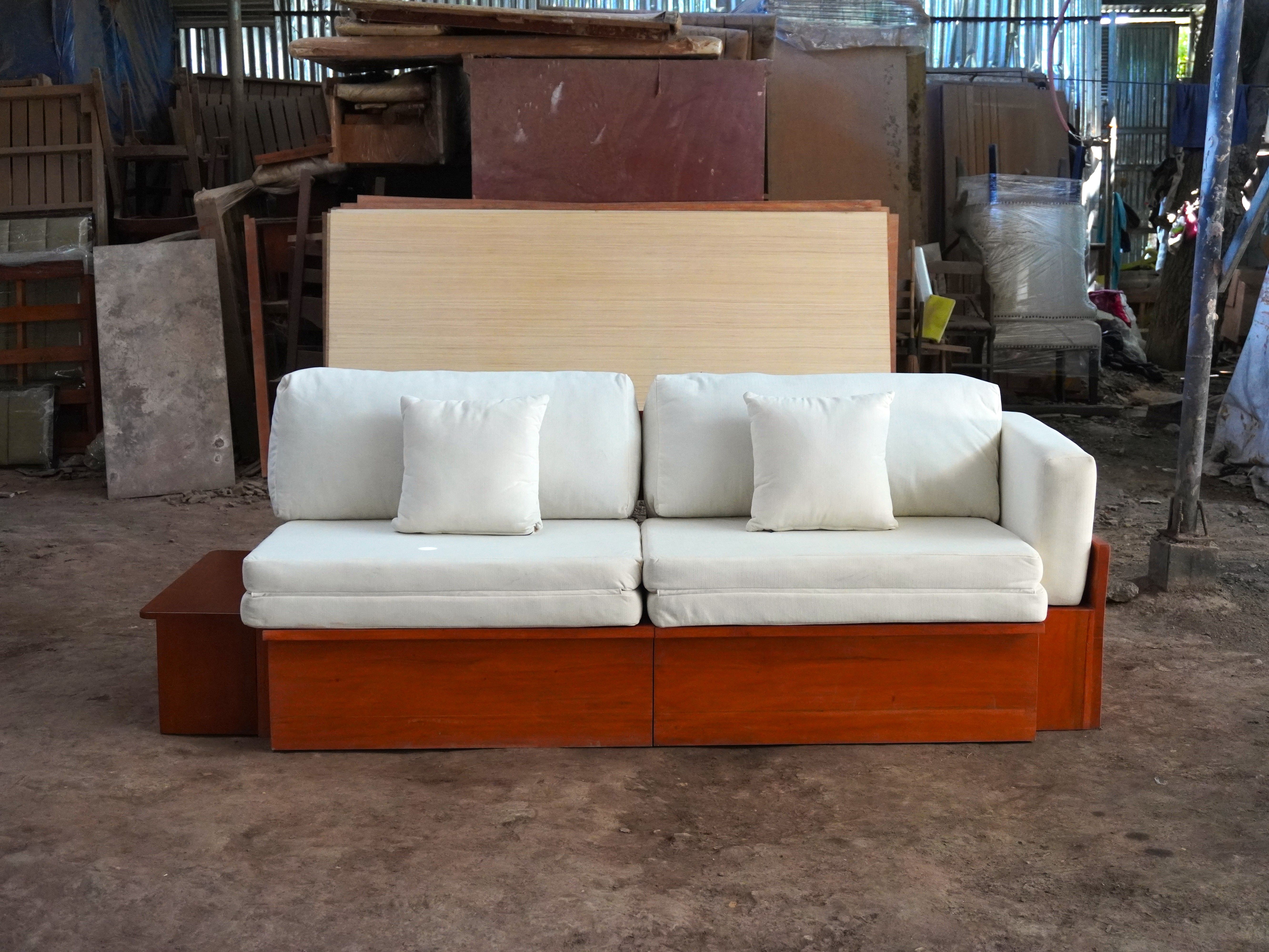 One piece, three ways to use it: a cozy sofa, a roomy L-shape, or a full bed, all in a cream fabric finish with a warm wood frame.