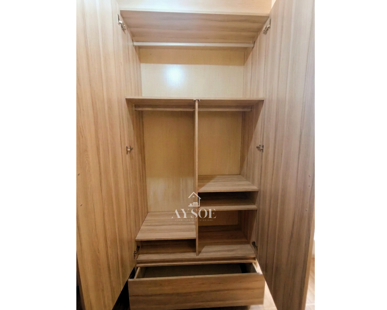 A custom light oak wardrobe with a full-length mirror door, a roomy bottom drawer, and overhead cabinets. Complete bedroom storage in a clean, modern design.