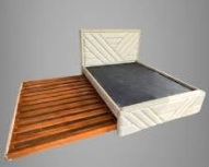 The high headboard features an elegant, asymmetrical chevron or V-shaped geometric panel pattern.