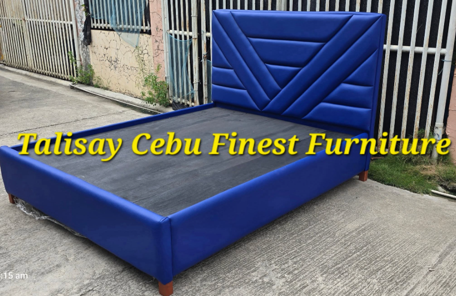 Constructed from a mahogany wood bed frame and upholstered with leatherette.