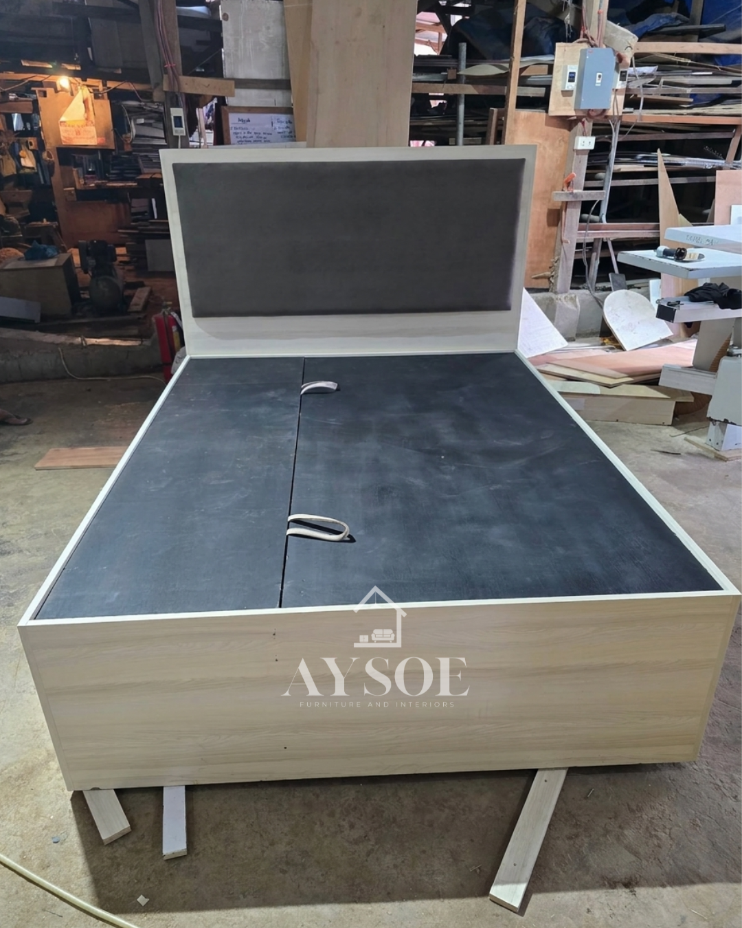 A light oak storage bed with a lift-up platform, four side drawers, and a padded grey headboard. Huge hidden storage for bedding, clothes, and extras.