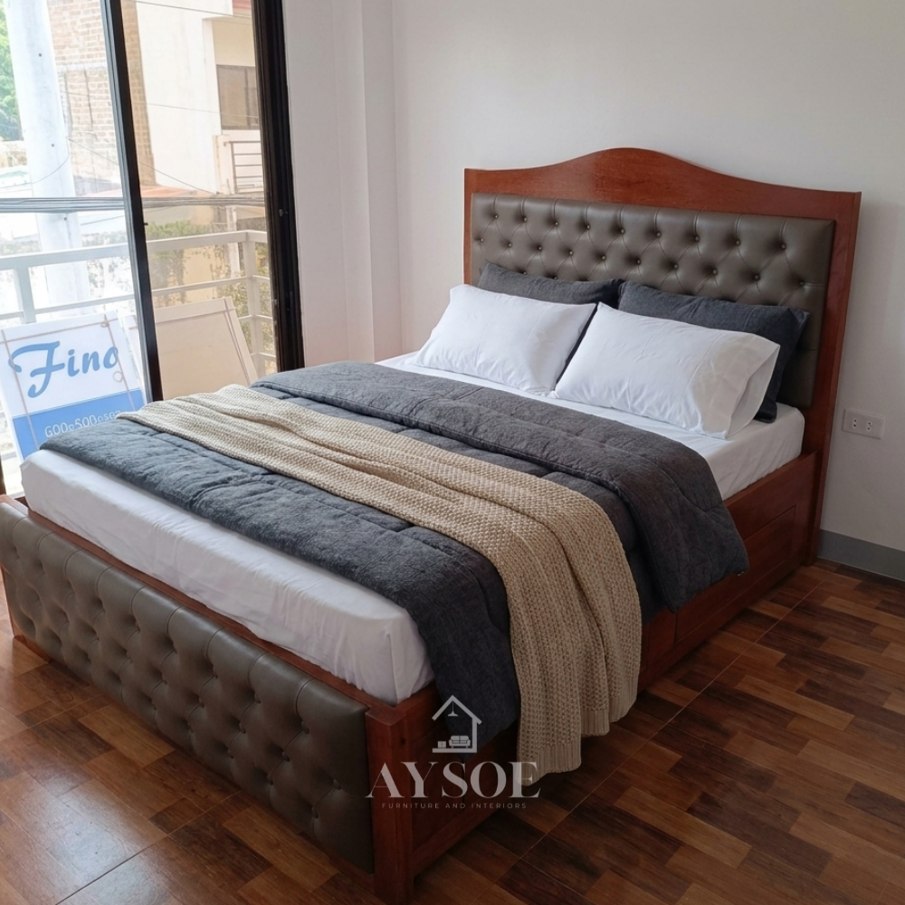 A solid wood bed in a rich glossy cherry finish, with an arched headboard, taupe button-tufted leatherette panels on the headboard and footboard, a slatted base, and built-in side drawers.