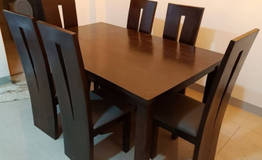 Chairs: Six matching tall-back wooden chairs. Each backrest features a distinctive, sleek vertical rectangular cut-out design running down the center.