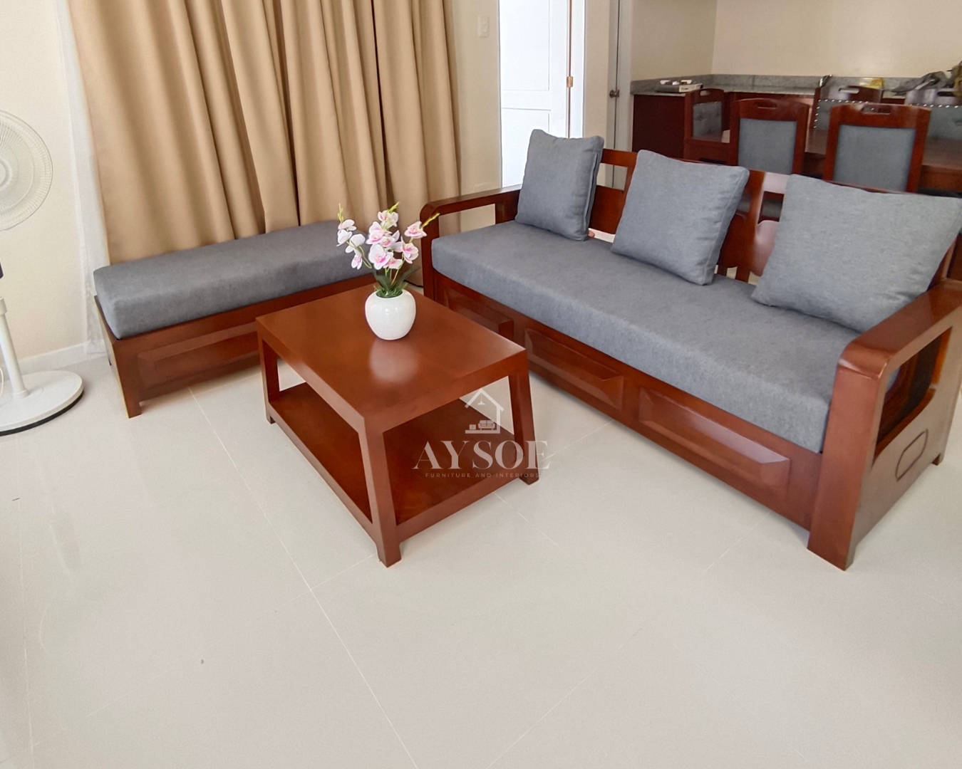 Cherry-finish solid wood living set: 3-seater sofa, matching chaise bench, and coffee table, with thick gray cushions and large lumbar pillows. Comfortable and easy to style.